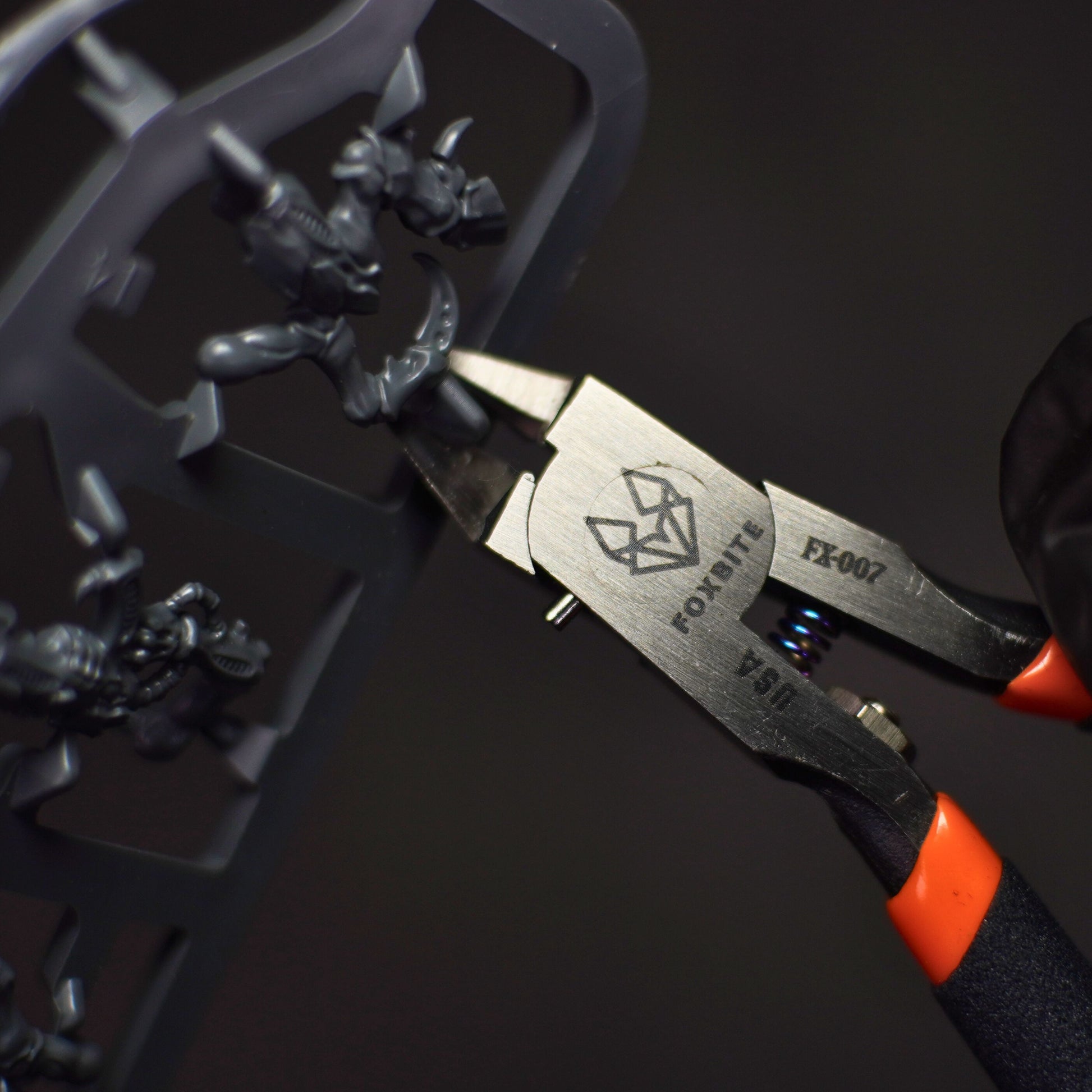 "Close-up of FOXBITE FX007 Nippers with ergonomic grip and spring-loaded design"

